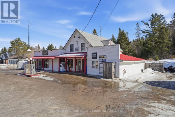 Close-up view of building entrance with signage and trailer parked nearby. - 34820 Ab Hwy 62 Highway, Hastings Highlands