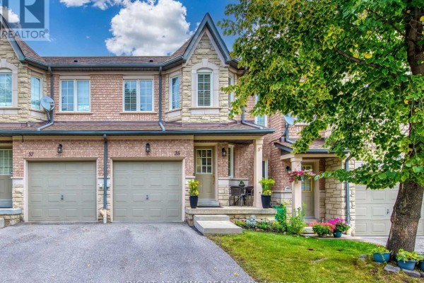 Front exterior view of townhouse unit 35 with garage, porch, and landscaping. - 35 - 5260 Mcfarren Boulevard, Mississauga