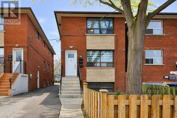 Close-up of the entrance to 35 Fifteenth Street, Toronto, showing red brick and light beige brick details. - 35 Fifteenth Street, Toronto