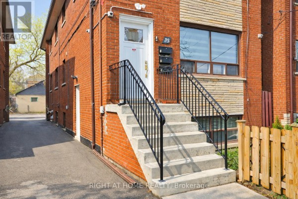 Concrete steps with black metal railings leading to the entrance of 35 Fifteenth Street, Toronto. - 35 Fifteenth Street, Toronto