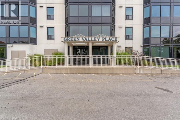 The entrance to "Green Valley Place" building with a glass facade and aluminum trim. - 35 Green Valley Drive Unit# 308, Kitchener
