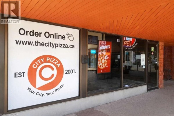 Exterior view of a pizza restaurant with a large sign featuring the 'City Pizza' logo and website address. - 35 Harvard Road Unit# 10, Guelph