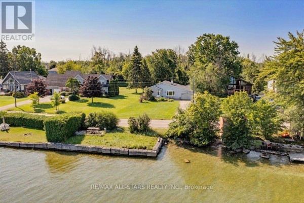 View of the house and surrounding properties from the lake. - 35 Lake Drive E, Georgina