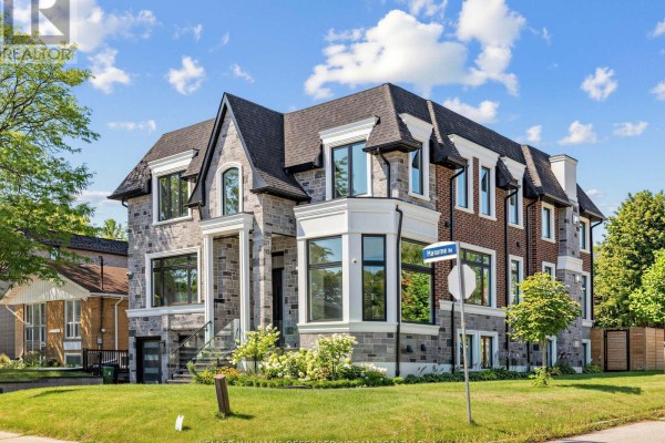 Side view of a grey stone and red brick house with a bay window and a street sign reading "Lloydminster Cres". - 35 Lloydminster Crescent, Toronto