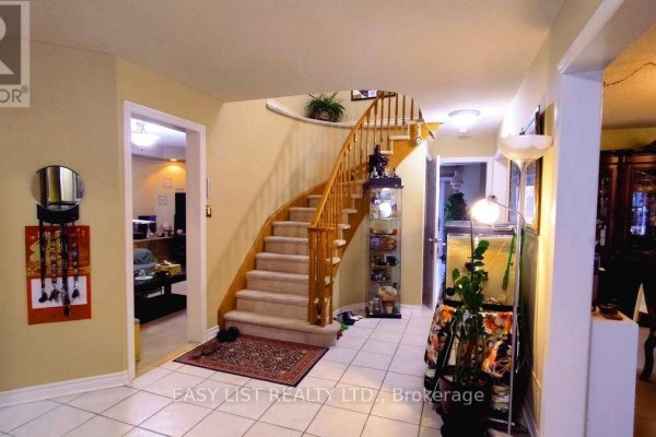 Bedroom with tan walls, ceiling fan, and double closet, featuring a patterned bedspread - 35 Raquel Street, Barrie