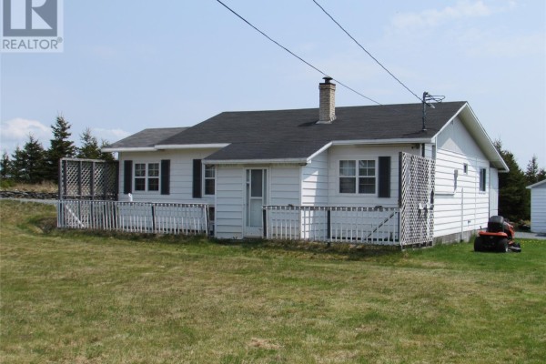 Side view of bungalow with white siding, dark shutters, and white deck. - 35 Ryan's Hill, Colliers