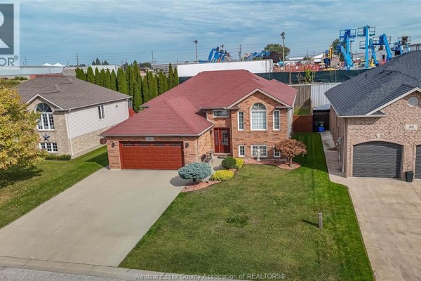 Aerial view of a house with a red roof, brick exterior, and adjacent properties. - 35 Sandy Lake, Leamington