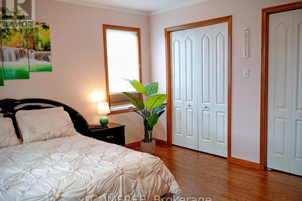Bedroom with bed, plant, and closet doors - 35 Tanya Drive Southwest Middlesex