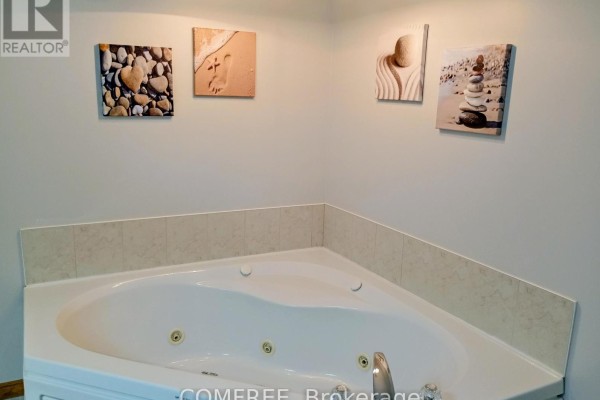 Corner jacuzzi tub with decorative wall art - 35 Tanya Drive Southwest Middlesex