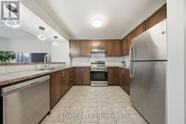 Kitchen with stainless steel appliances, wood cabinets, and tile flooring - 35 Thames Way Hamilton
