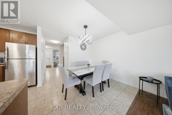 Modern dining set and chandelier with kitchen view - 35 Thames Way Hamilton