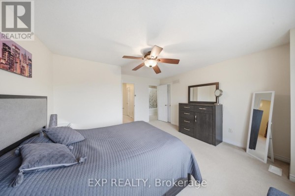 Bedroom with bed, dresser, and ceiling fan - 35 Thames Way Hamilton