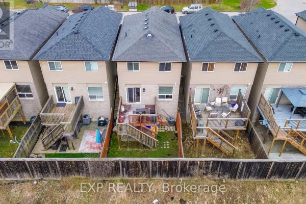Townhouse backyards with decks and fences - 35 Thames Way Hamilton