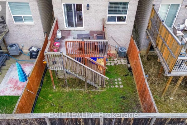 Backyard with deck, grill, patio, and AC units - 35 Thames Way Hamilton
