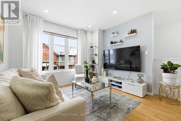 Bedroom with a queen-sized bed, bedside tables, wood floors, and white curtains. - 35 Ventura Lane, Ajax