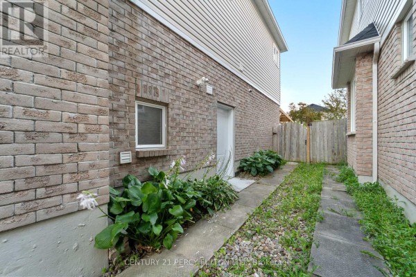 Interior view of a bright foyer with a tiled floor, wooden staircase, and hallway. - 35 Weldon Street, Whitby