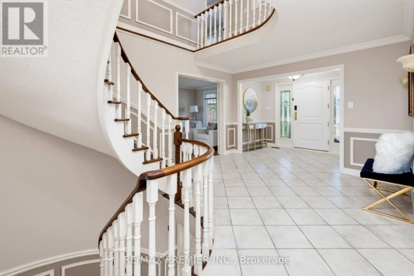 Foyer with a grand white staircase, tiled floor, and views into other rooms. - 35 Yellow Pine Crescent, Vaughan