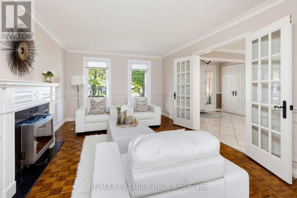 Living room with a white fireplace, white furniture, French doors, and parquet flooring. - 35 Yellow Pine Crescent, Vaughan