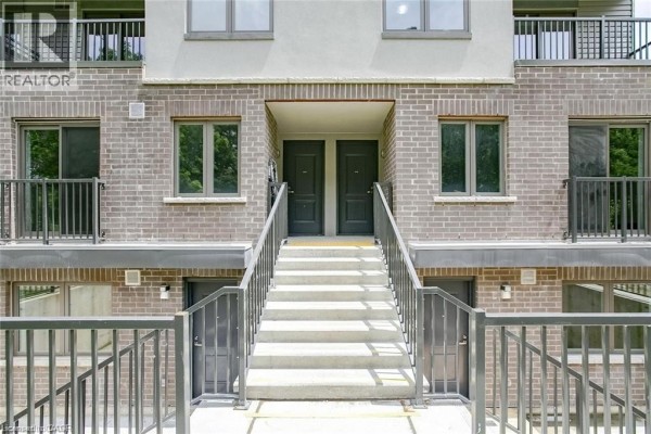 Close-up of two identical dark gray front doors with stairs leading up. - 350 Fisher Mills Road Unit# A-11, Cambridge