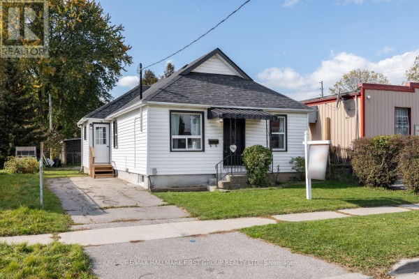 Sunroom with green carpet, bamboo blinds, and a glass door leading outside. - 350 Oshawa Boulevard S, Oshawa