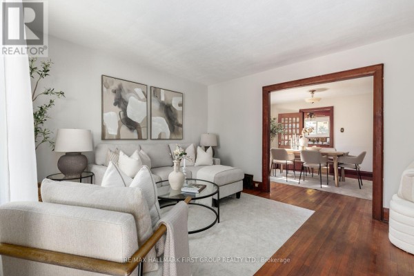 Unfinished basement with concrete floor, wooden shelves, and a large white screen. - 350 Oshawa Boulevard S, Oshawa