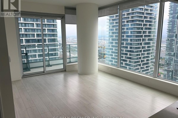 Spacious living area with panoramic windows overlooking the city and a large white pillar. - 3502 - 5 Buttermill Avenue, Vaughan