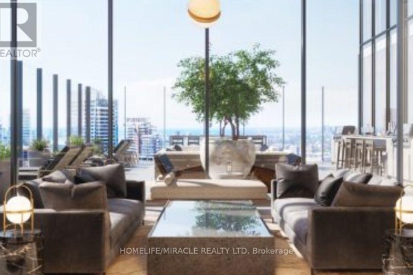 Indoor lounge area with modern furniture, large windows, and city views. - 3505 - 55 Charles Street E, Toronto