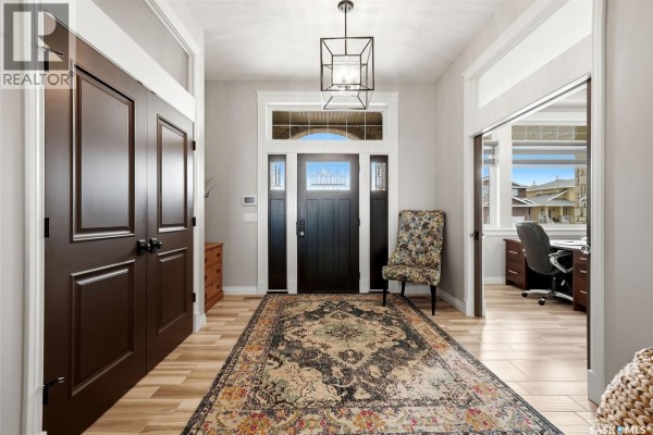 Bathroom with a white toilet, a glass-enclosed shower stall, and wood-look tile flooring. - 3505 Green Brook Road, Regina