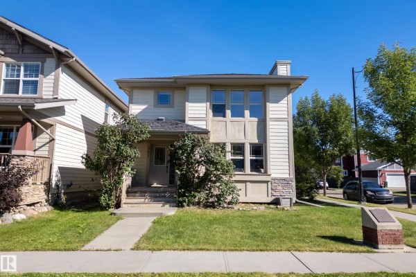Side view of the house showcasing large windows and a covered porch - 351 Griesbach School Rd Nw, Edmonton