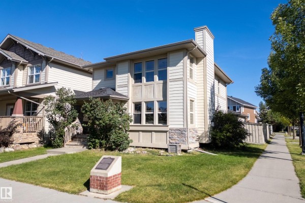 Entryway with tile flooring, decorative dolphin sculpture, and coat storage - 351 Griesbach School Rd Nw, Edmonton
