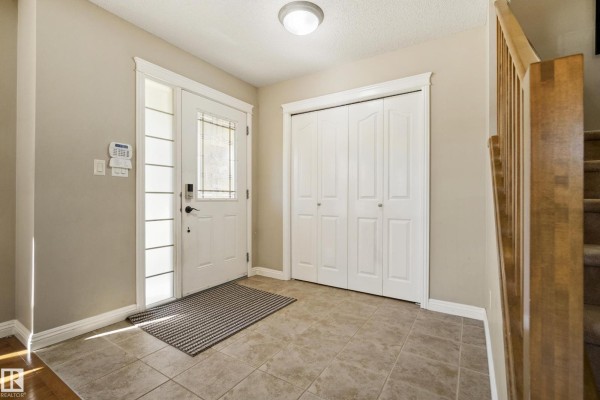 Entryway featuring a glass-paneled door and access to the living room - 351 Griesbach School Rd Nw, Edmonton