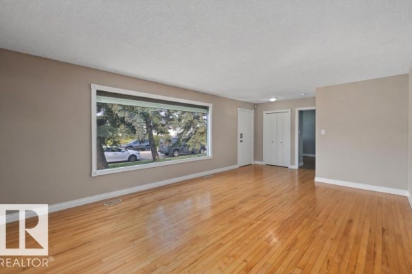 Open concept living and dining area with hardwood floors and natural light. - 3511 73 St Nw, Edmonton