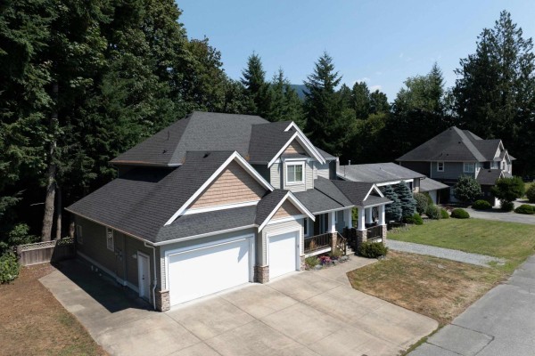 Aerial view of the front of a large two-story house with a grey roof and attached garage. - 35159 Mcewen Avenue, Mission