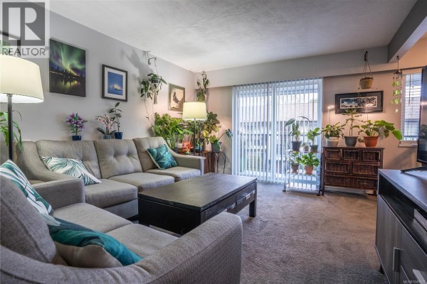 Balcony view with railing overlooking greenery and nearby trees. - 352 Burnside Rd W, Saanich