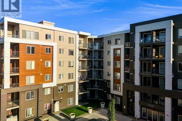 Close-up exterior view of modern apartment buildings with balconies and wood accents. - 3520, 4641 128 Avenue Ne, Calgary