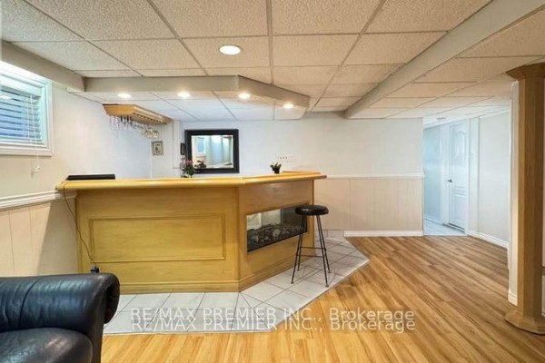 A small kitchen with white cabinets, stainless steel appliances, and grey countertops. - 3551 Burningelm Crescent, Mississauga