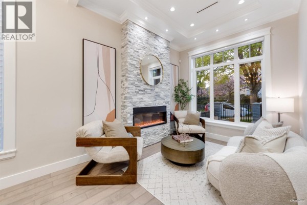 Compact laundry area with a stacked white washer and dryer unit. - 3582 Franklin Street, Vancouver