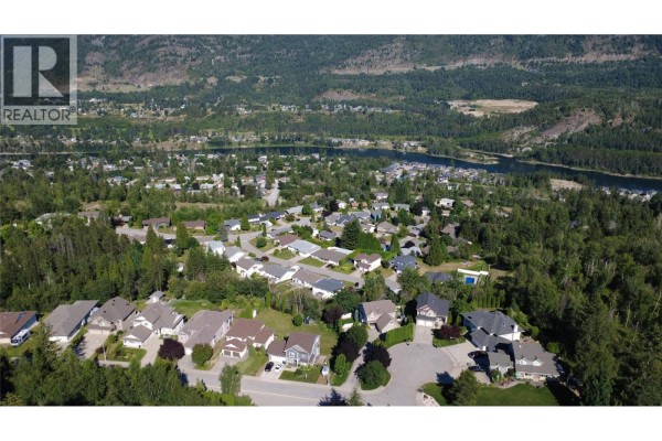 Aerial view of neighborhood with rocky terrain and trees - 3583 14th Avenue, Castlegar