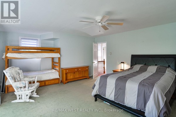 Bedroom with bunk beds, rocking chair, dresser, and queen bed - 3587 Lauderdale Point Crescent Severn