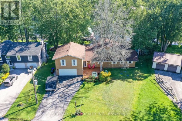 Beige house with deck, garages, and boat trailer - 3587 Lauderdale Point Crescent Severn