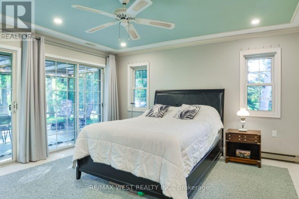 Bedroom with bed, ceiling fan, sliding doors to patio - 3587 Lauderdale Point Crescent Severn