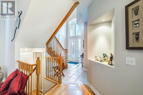 Foyer with a staircase, entryway, and a built-in wall niche. - 3598 Fountain Park Avenue, Mississauga