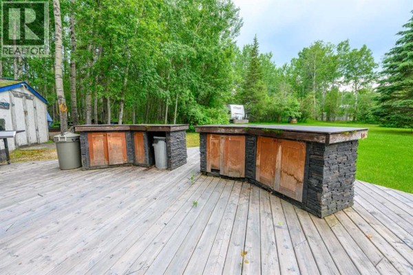 Two curved outdoor kitchen counters with stone bases and wooden cabinets on a deck. - 36, 70544 243 Range, Rural Greenview No  16, M D  Of