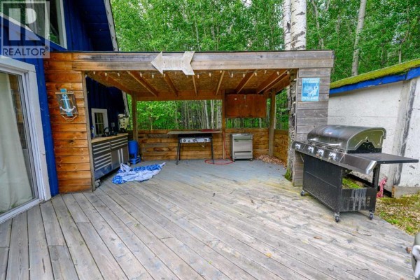 Covered outdoor kitchen area with grills, stainless steel cabinets, and picnic tables. - 36, 70544 243 Range, Rural Greenview No  16, M D  Of
