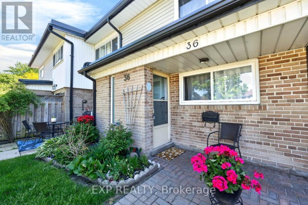 Front entrance of townhouse unit 36 with brick facade and potted flowers. - 36 - 925 Bayly Street, Pickering