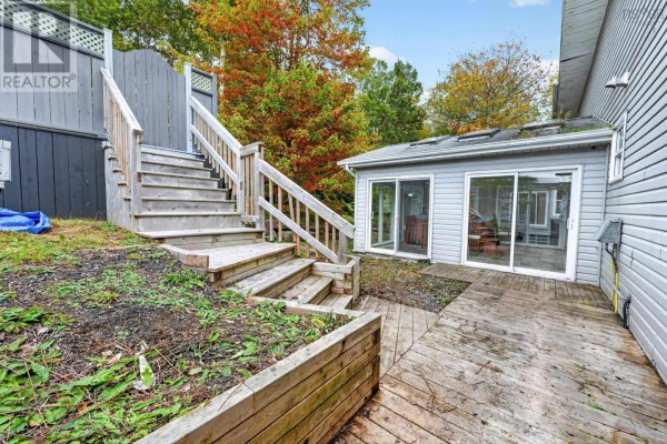 Wooden stairs and deck leading to a sunroom with glass sliding doors. - 36 Bradmoor Crescent Crescent, Sydney River
