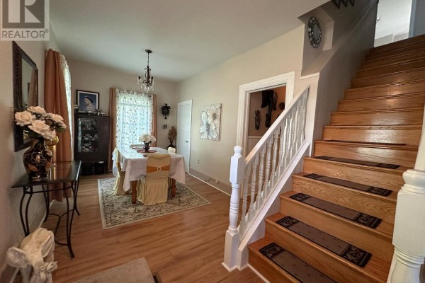 Interior view of a dining room with a table set for four and a staircase. - 36 Brouse Drive E, South Dundas