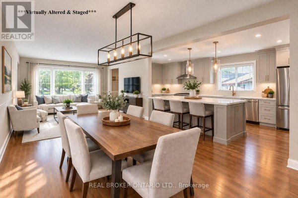 Open-concept dining room, living room, and kitchen with a large island. - 36 Dutch Settlers Court, East Gwillimbury