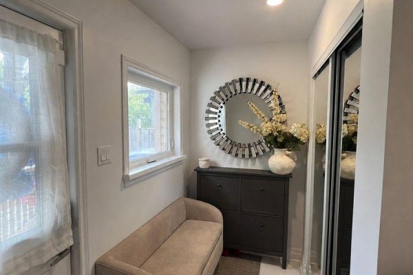 Hallway entrance with a bench, shoe cabinet, large decorative mirror, and a closet. - 36 Fergus Avenue N, Richmond Hill
