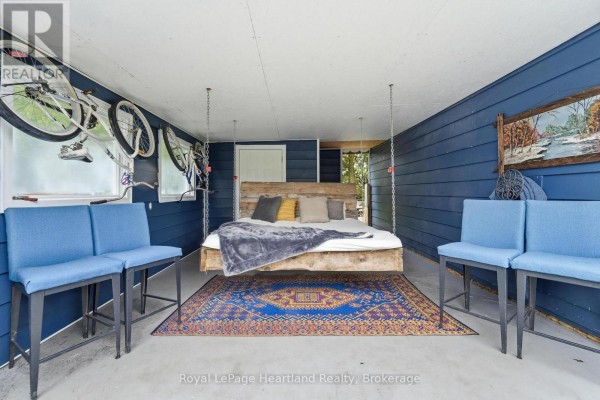 Covered outdoor area featuring a suspended bed, bicycles on wall, and seating. - 36 Jane Street, Bluewater